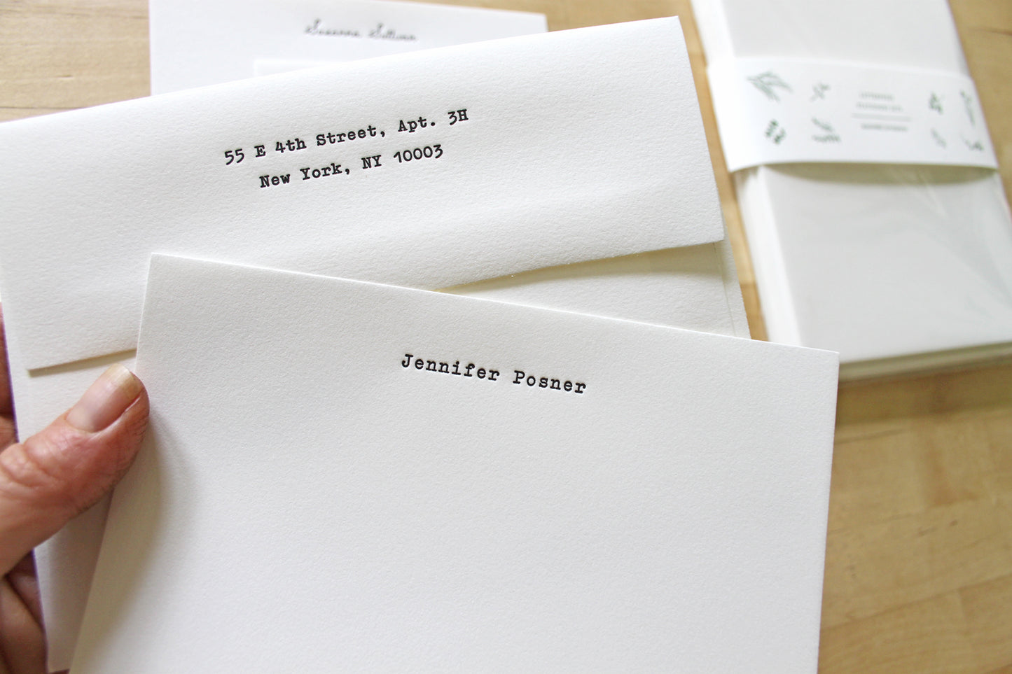 Letterpress stationery sheet showing typewriter typeface option with return address