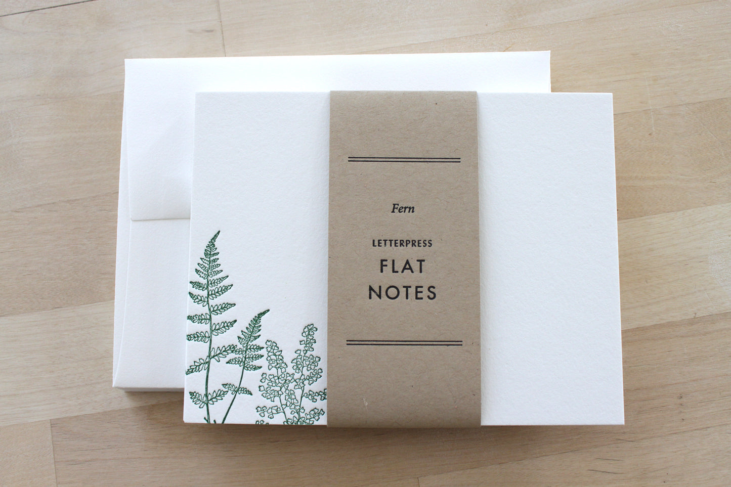 Close-up of letterpress fern illustration pressed into recycled cotton notecard