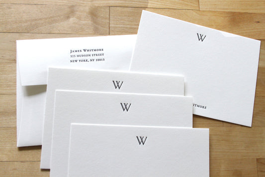 Personalized letterpress notecards with double-stroke W initial, fanned stack with matching return address envelope, cotton paper stationery for professionals