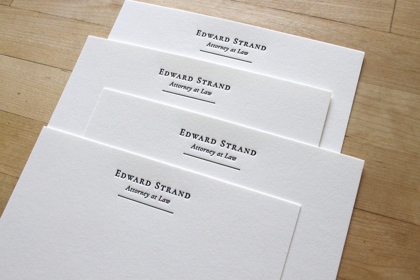 Name + Title letterpress stationery with serif name, italic title, and fine rule line at top left, personalized business stationery on cotton paper