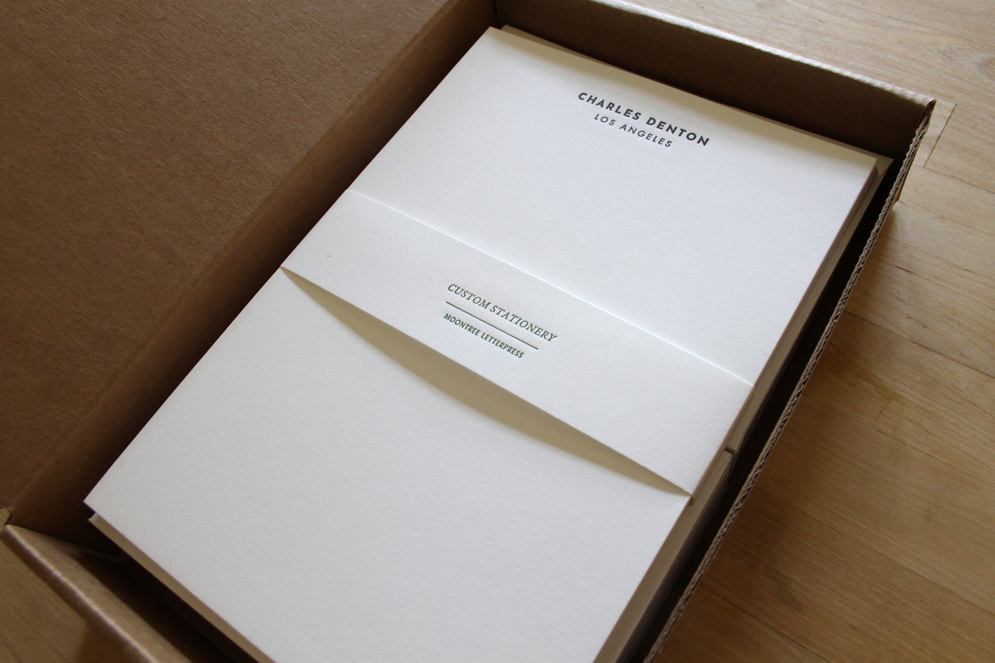 Clean-lined letterpress stationery stack with bold name and city, boxed with matching envelopes for professional correspondence