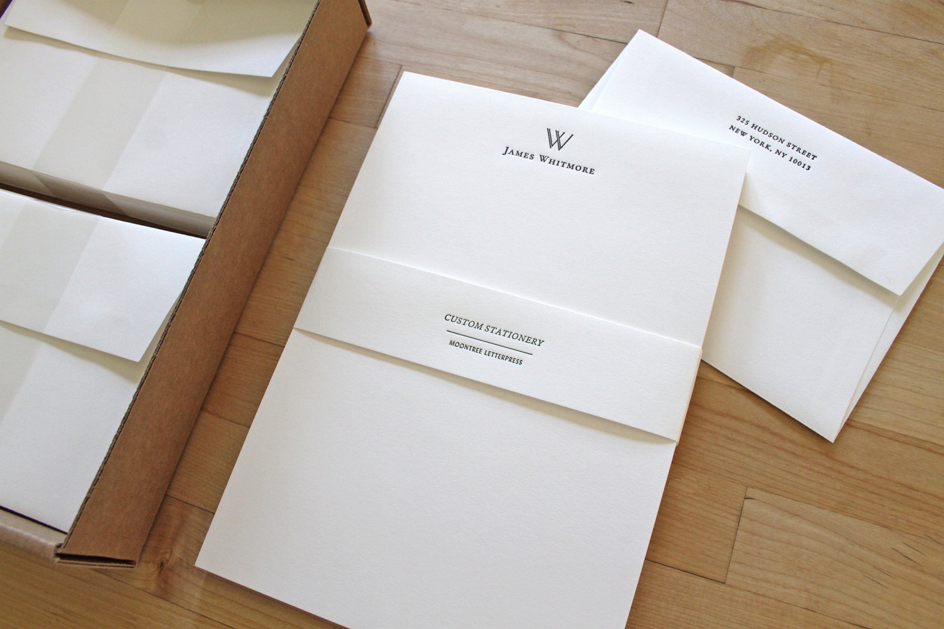 Letterpress correspondence set with architectural initial, packaged with matching return-address envelopes