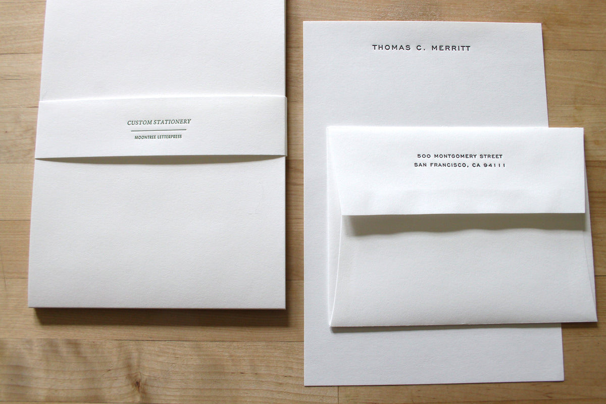 Letterpress stationery shown in Engravers font option, with matching envelope and printed return address