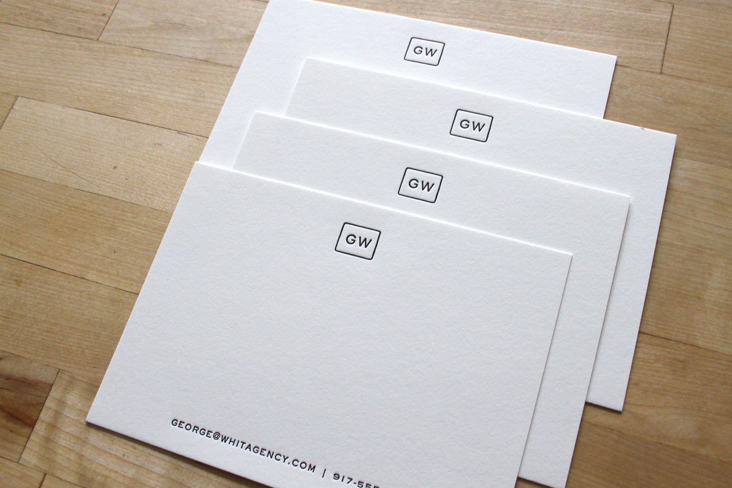 Stack of personalized squared initials letterpress business notecards on cotton paper