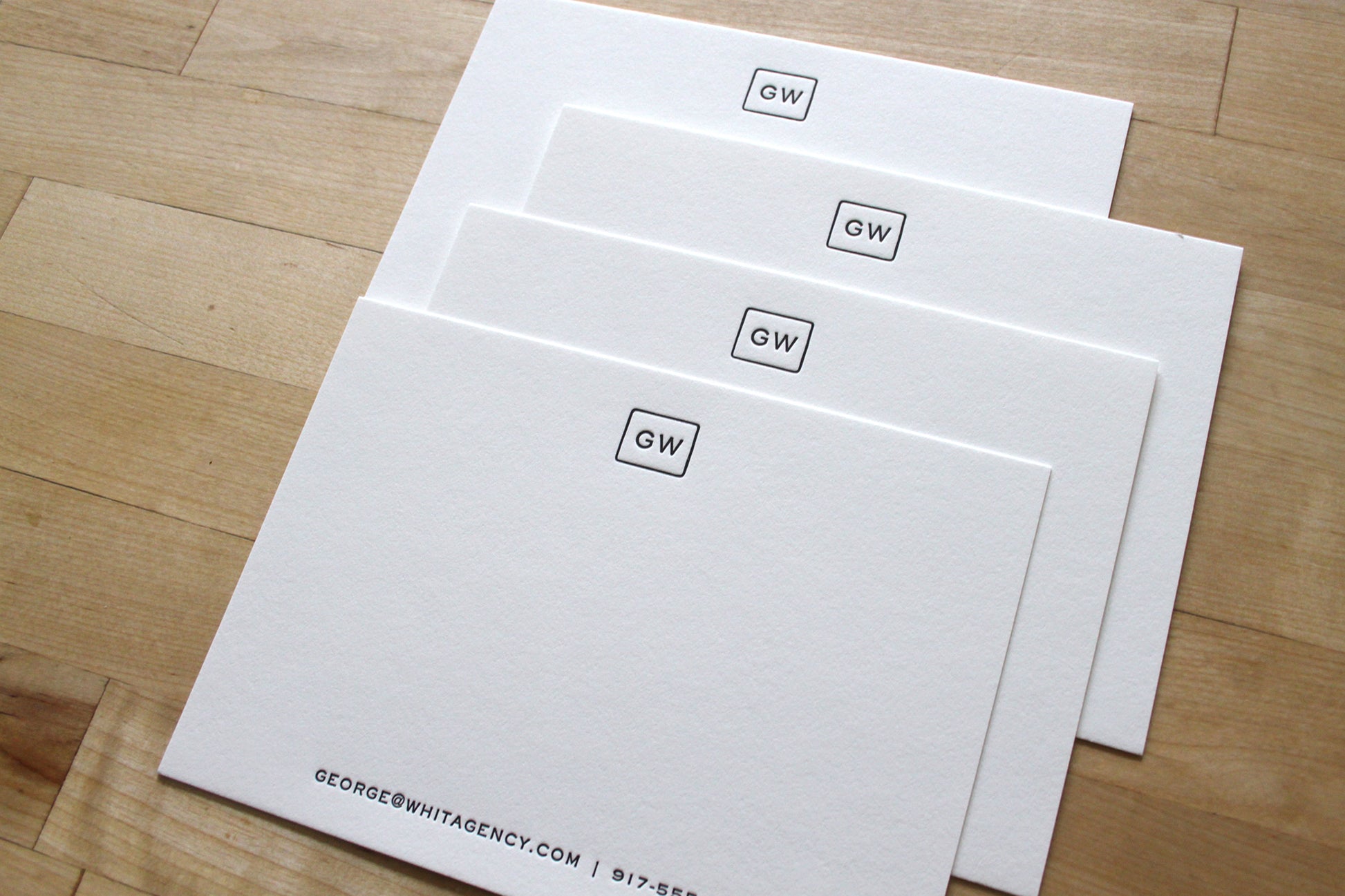 Stack of personalized squared initials letterpress business notecards on cotton paper
