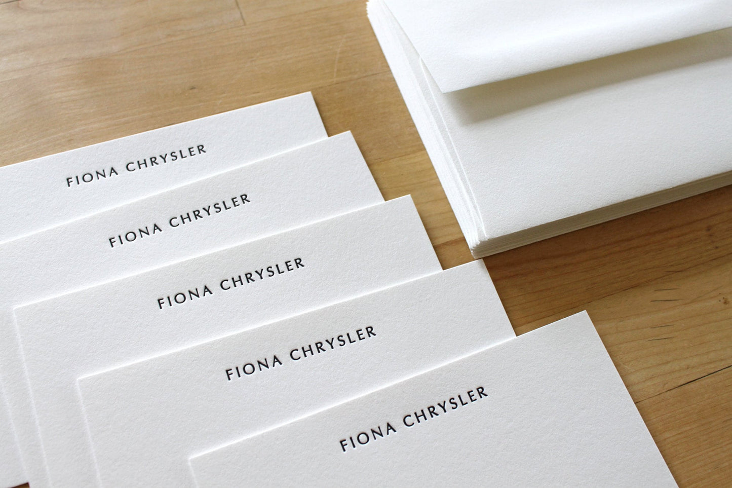 Fan of Optima personalized letterpress notecards with name in elegant sans serif font on cotton paper