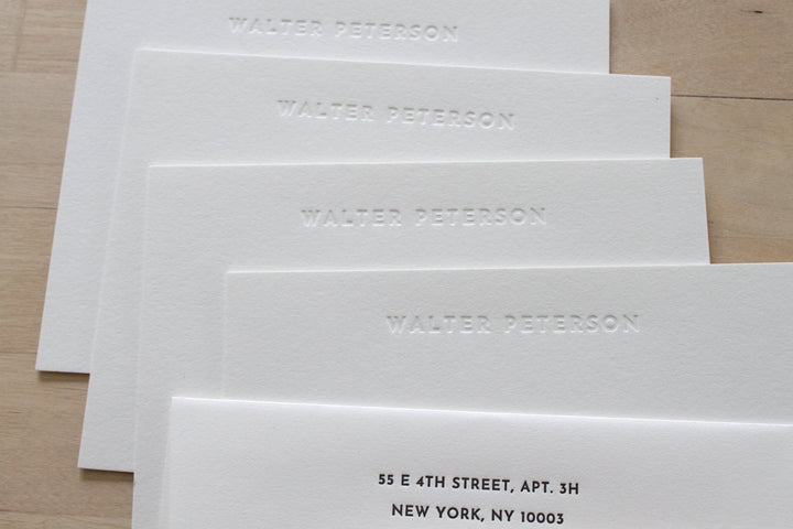 Minimalist blind embossed letterpress stationery with name pressed into cotton paper and return addressed envelope