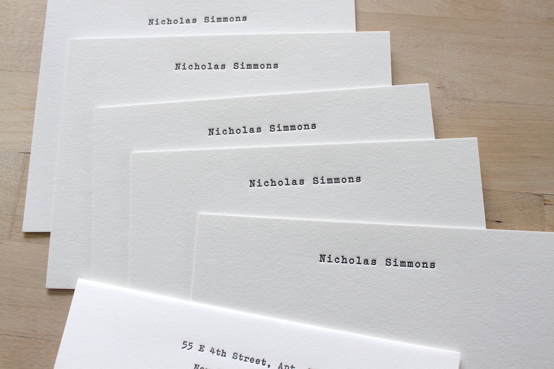 Fan of typewriter style personalized letterpress notecards with return address