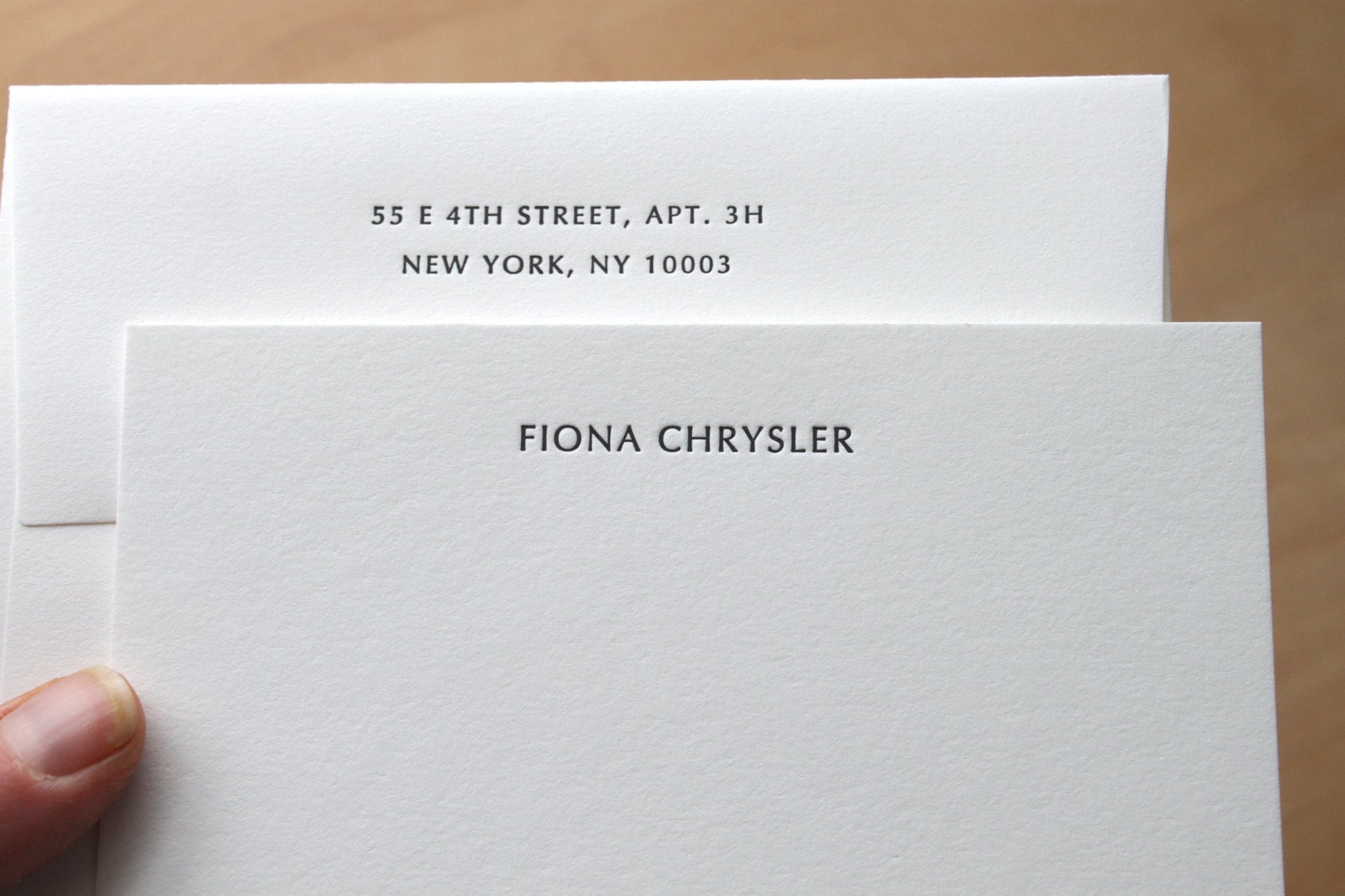 hand holding Optima personalized letterpress stationery close-up