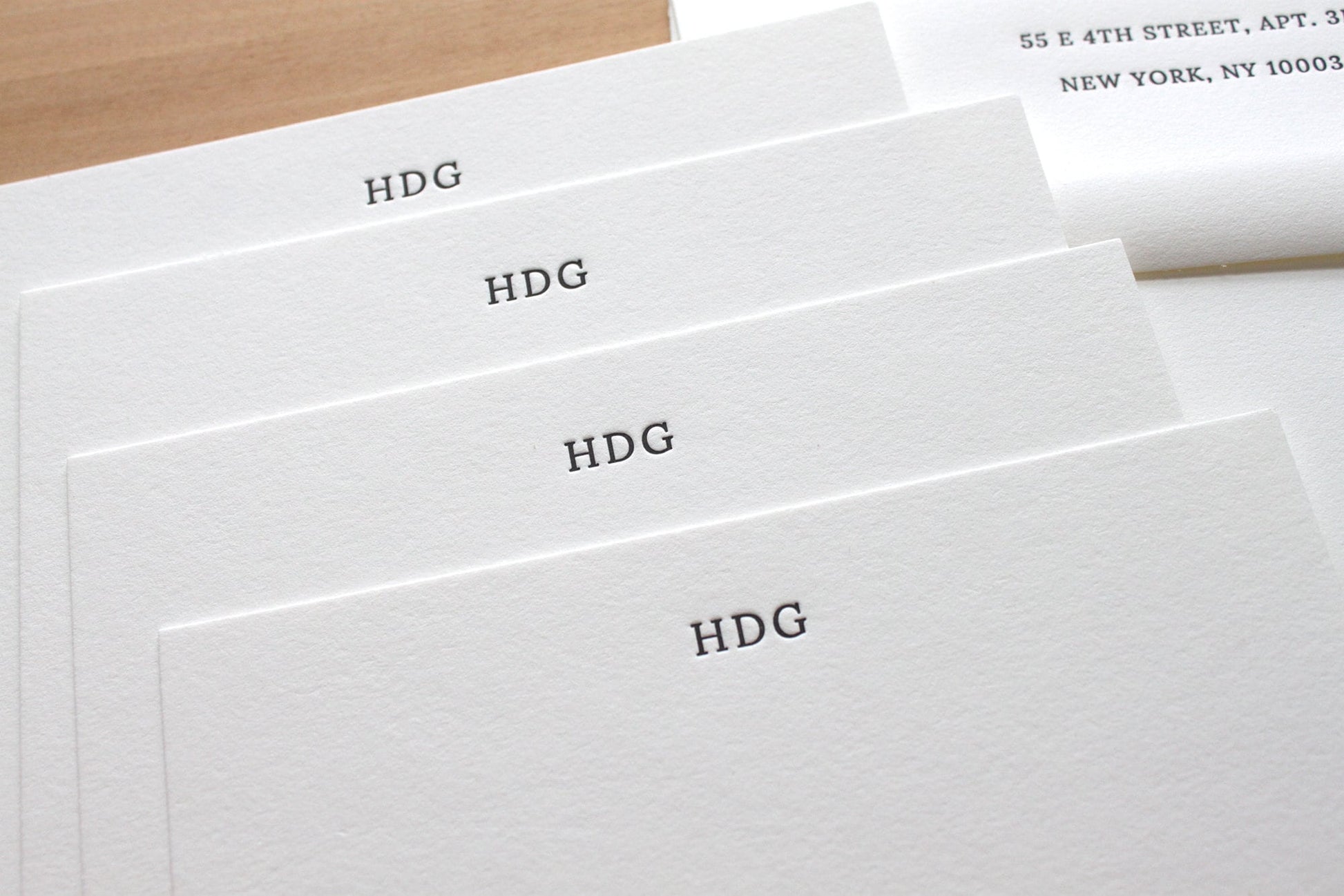 Fan of small initials personalized letterpress notecards showing HDG monogram on cotton paper